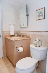 a bathroom with a white toilet and a sink at 117 Sapphire Beach Condo in Christ Church