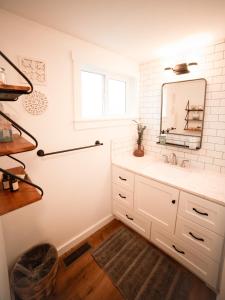 a bathroom with a sink and a mirror at The Heritage House in Klamath Falls