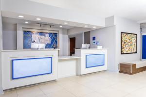 a waiting area in a clinic with blue screens at Holiday Inn Express Hotel & Suites Jacksonville - Mayport / Beach, an IHG Hotel in Jacksonville