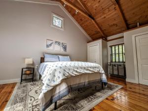 a bedroom with a bed and a wooden ceiling at Acadia Park Suites Condo in Southwest Harbor