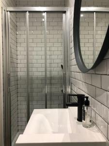 a bathroom with a white sink and a mirror at Lisbon deluxe city center flat in Lisbon