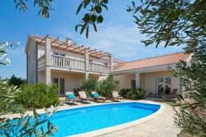 a villa with a swimming pool and a house at Doris Hvar in Rudina