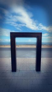 a wooden frame sitting on top of a beach at Appartement El jadida Sidi Bouzid in Sidi Bouzid