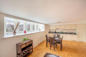 a kitchen and dining room with a table and chairs at Monastery apartment with Loch Ness view in Fort Augustus