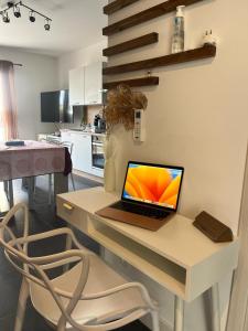a laptop computer sitting on a desk in a kitchen at tytoun evasion in Borgo +20 photos