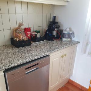 a kitchen with a counter top with some items on it at Casa panorama 314 San Agustín Maspalomas in San Agustin