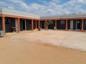 an empty parking lot in front of a building at Letz Guest Lodge in Tolwe