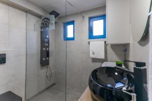 a bathroom with a black sink and a shower at Otus in Kraj +34 photos