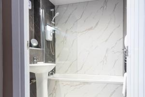 a bathroom with a sink and a shower at Grove House in North Queensferry