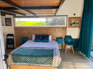1 dormitorio con cama y ventana en Petit chalet en Nernier