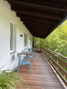 a wooden deck with chairs and tables on it at Fi-Ferienhaus in Waldeck