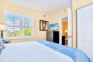 a bedroom with a large white bed and a window at Condo Close to Universal Studios - Pool Hot Tub in Orlando