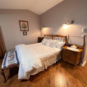 a bedroom with a large bed and a night stand at Colemore Hotel in Coleman