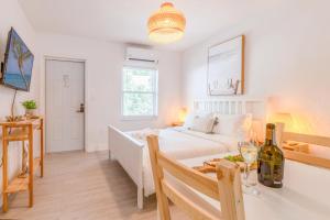 a bedroom with a bed and a table with a wine bottle at Casa Agave Miami in Miami