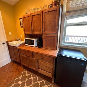 a kitchen with a counter with a microwave and a sink at Colemore Hotel in Coleman