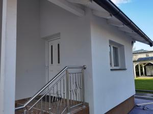 a white building with a door and a staircase at Haus in Murfeld Graz in Graz