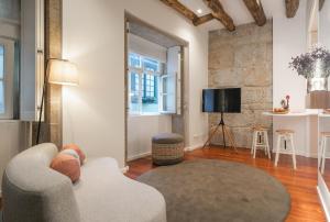a living room with a couch and a television at Bandeiras in Porto