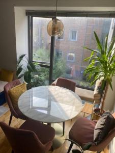 a dining room with a table and chairs and a window at Oasis in heart of Dublin city in Dublin