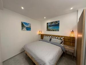 a bedroom with a bed and two pictures on the wall at B&B Casa Limone in Limone sul Garda