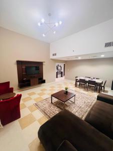 a living room with a couch and a table at AlRaef Luxury Apartments in Dubai