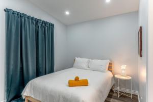 a bedroom with a bed with a yellow box on it at Centrally located 4Bedroom, 2Bath Home in Yellowknife