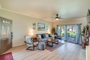 a living room with a couch and a table at Palm Desert Condo with Patio and Community Perks! in Palm Desert