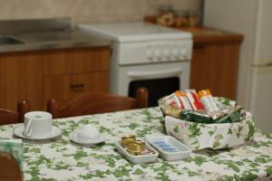 a kitchen table with a tablecloth with a bag of food at B&B La Petite Maison in Santa Domenica