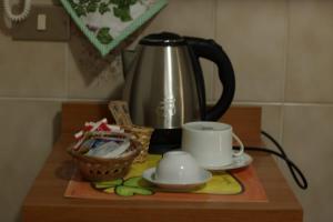 a coffee pot and cups on a wooden table at B&B La Petite Maison in Santa Domenica