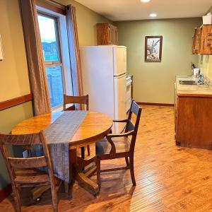 a kitchen with a table and a white refrigerator at Colemore Hotel in Coleman