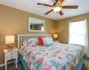 a bedroom with a bed and a ceiling fan at House# 60 Point of View (pet friendly) in Centre