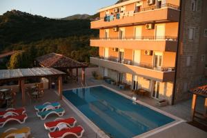 an image of a hotel with a swimming pool at Apartments Đurašević in Sveti Stefan