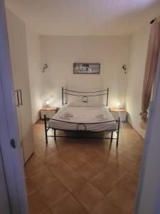 a bedroom with a bed and two night stands at Reef Fiumicino in Fiumicino