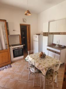 a kitchen with a table and chairs and a kitchen with a stove at Reef Fiumicino in Fiumicino
