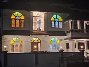 a building with colorful stained glass windows at night at Hestia Chalet 3BHK Villa in Ooty