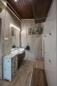 uma casa de banho com um lavatório, um espelho e um balcão em Nr8 Prémium Vendégház em Makó