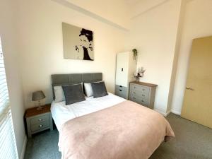 1 dormitorio con 1 cama grande y 2 mesitas de noche en Central 3BR home in Manchester, en Mánchester