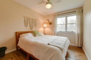Un dormitorio con una cama grande y una ventana en East Aurora Home about 18 Mi to Downtown Buffalo!, en East Aurora