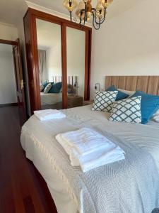 ein Schlafzimmer mit einem Bett mit zwei Handtüchern darauf in der Unterkunft Apartamento Boiro centro in Boiro