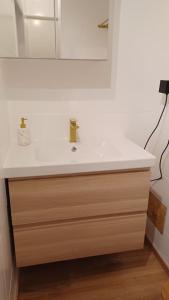 a bathroom with a white sink and a mirror at Pépite in Dinant +15 photos