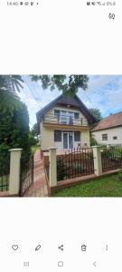 a picture of a house with a fence at Zita Vendégház in Dombóvár