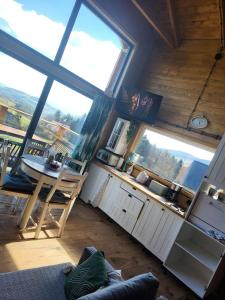 a room with a kitchen with a table and windows at Dream Catcher House 