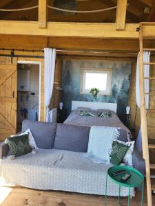 a bedroom with a bed and a couch in a room at Dream Catcher House - dom z widokiem na góry in Limanowa