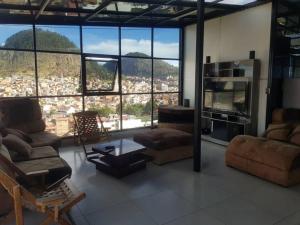 a living room with a view of a city at penthouse panorámico in Sucre