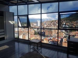 a room with a large window view of a city at penthouse panorámico in Sucre