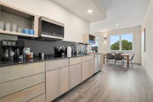 a kitchen with wooden cabinets and a table in it at Staggerwing-MTB Oasis in Bella Vista