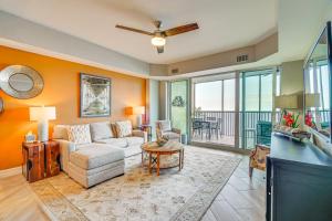 a living room with a couch and a table at Riverfront Fort Myers Condo with Community Amenities in Fort Myers