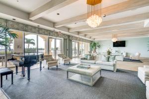 a living room filled with furniture and a piano at Riverfront Fort Myers Condo with Community Amenities in Fort Myers