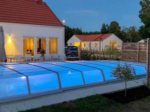 a swimming pool in front of a house at 5 star holiday home in Gotlands Tofta-By Traum in Tofta