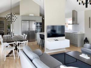 a living room with a couch and a tv and a table at 5 star holiday home in Gotlands Tofta-By Traum in Tofta