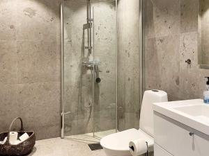 a bathroom with a shower with a toilet and a sink at 5 star holiday home in Gotlands Tofta-By Traum in Tofta +26 photos